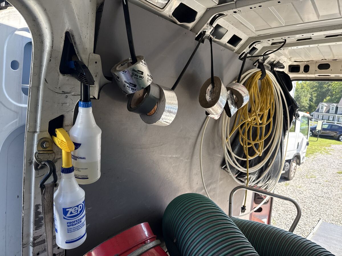 Van 2 slide door with spray bottles and tape rack on S-hooks